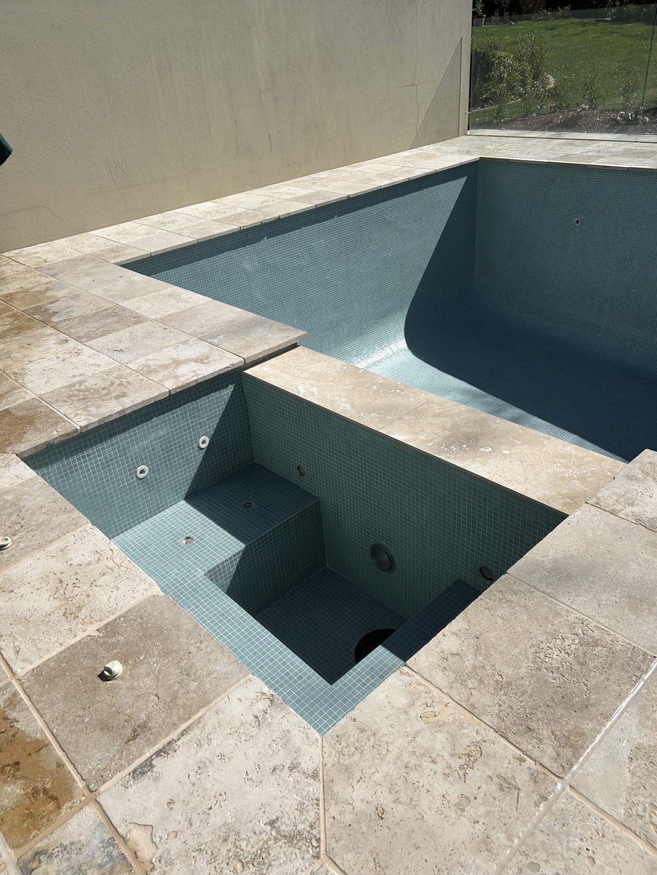 Fully tiled pool and spa with new travertine coping Canberra